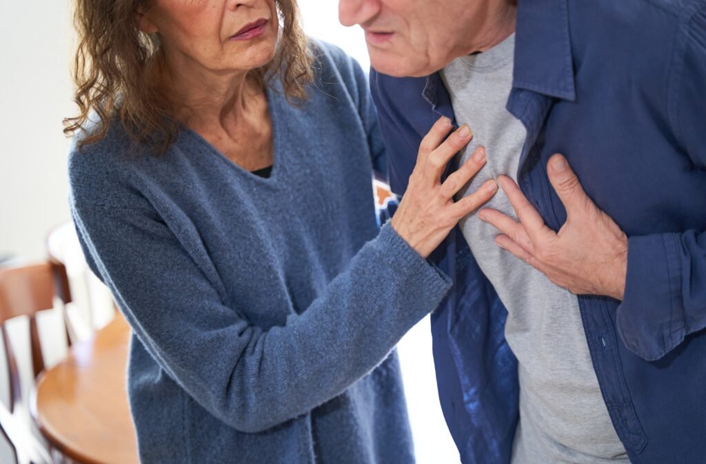 Woman giving her husband first aid during a heart attack and chest pain