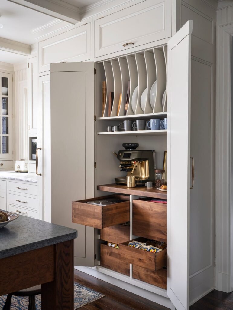 Designer Sarah Robertson kept the countertops clear in this kitchen by creating a coffee zone inside of a cabinet